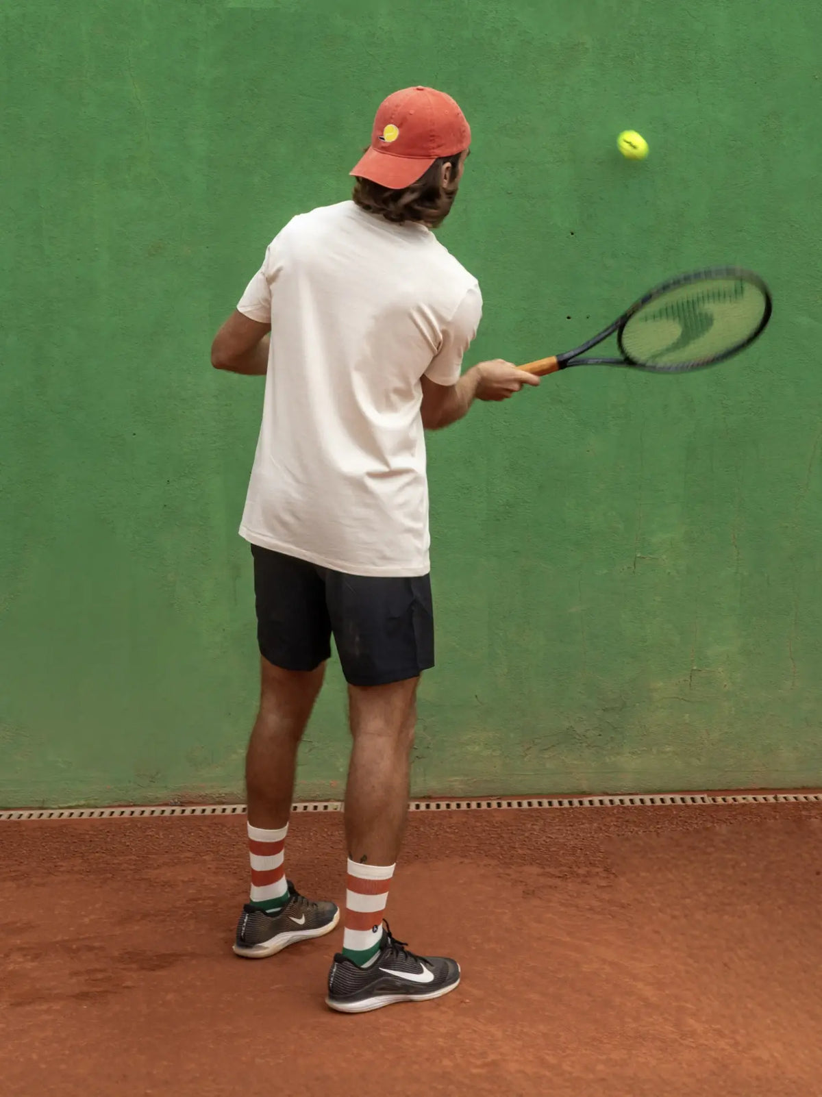 Futah Cap Tennis Ball – getragen am Model von hinten auf dem Tennisplatz